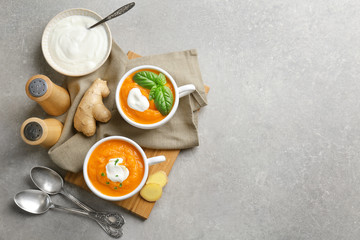 Composition with delicious carrot soup on table