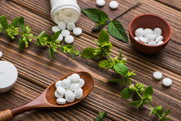 Fototapeta na wymiar Natural organic pills with herbal plant