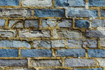 Ruined wall of brick gray.