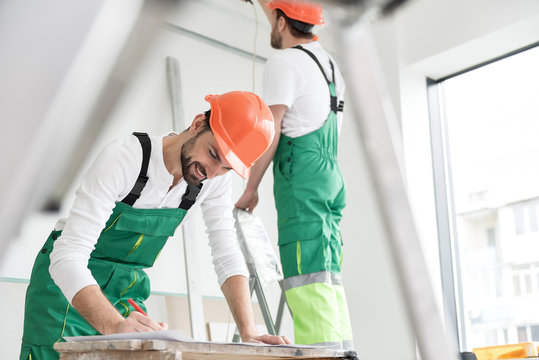 Outgoing master-builder protracting draft in apartment