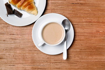 cup of coffee top view with croissant