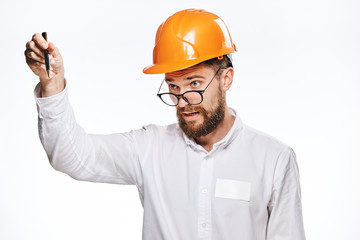 Engineer with a beard on a white isolated background holds blueprints