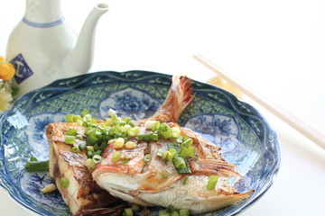 Chinese food, pan fried sea bream with spring onion and soy sauce