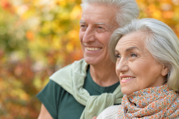 senior couple posing in the park