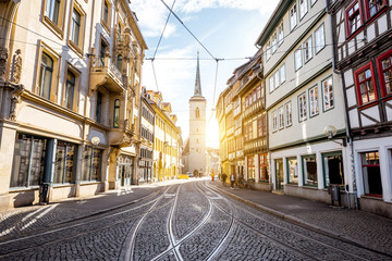 Street view with church tower at the old town of Erfurt city in Germany - obrazy, fototapety, plakaty