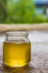 Honey in jar and window with green on backcground
