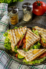 Panini sandwich with ham, tomato and lettuce.