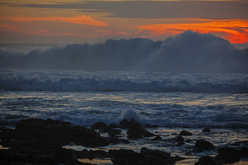 Big waves on bright dramatic sunset background on Lanzarote island seashore, Canary Islands, Spain