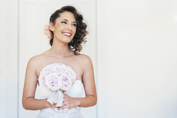 Bride trying on wedding dress.