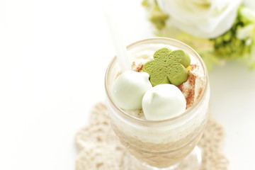 Iced coffee served with green tea cookie and marshmallow candy