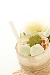 Iced coffee served with green tea cookie and marshmallow candy