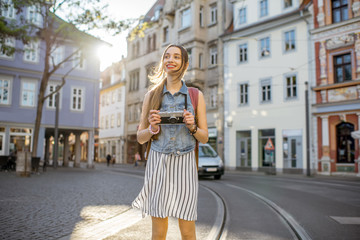 Portrait of a young woman tourist walking on the street in the old town of Erfurt city, Germany