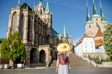 Morning view on the Mary Domberg cathedral with woman tourist in Erfurt city, Germany