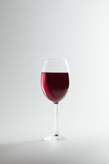 close-up view of wineglass full of red wine isolated on white