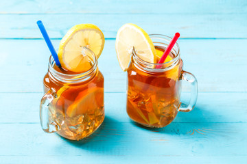 Iced tea in a glass jar with lemon.