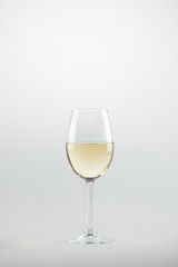 close-up view of wineglass full of white wine isolated on white