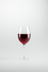 close-up view of wineglass full of red wine isolated on white
