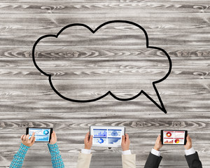 Top view of businesspeople sitting at table and using gadgets