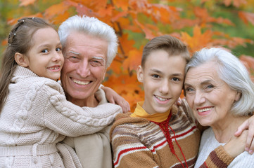 Fototapeta premium grandfather, grandmother and grandchildren in park 