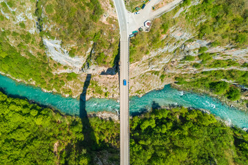 Road bridge over a river in the mountains, top view