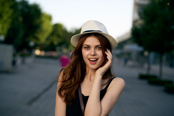 Young beautiful woman is walking in the city along the street