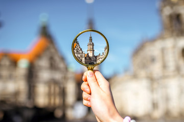 Watching though a magnifying glass on the Hausmannsturm tower of the old castle in Dresden, Germany