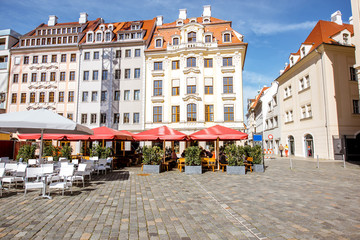Fototapeta na wymiar View on the beautiful buildings with cafe terrace on the main square in Dresden city, Germany