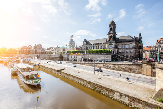 View on the riverside of Elbe river with beautiful buildings and church dome during the sunny weather in Dresden city, Germany