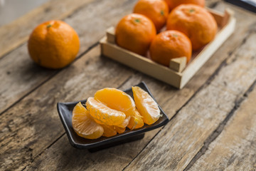 Ripe mandarine citrus . tangerine mandarine orange on wooden background. Mandarins in plate