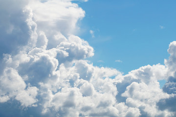 A blue sky with beautiful large fluffy clouds on a sunny and clear day.
