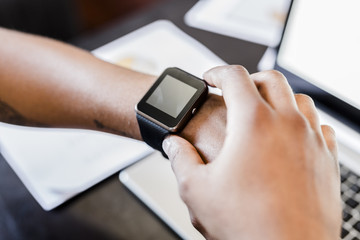 Close-up of businessman wearing smartwatch