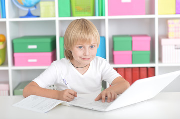 Cute little boy doing homework