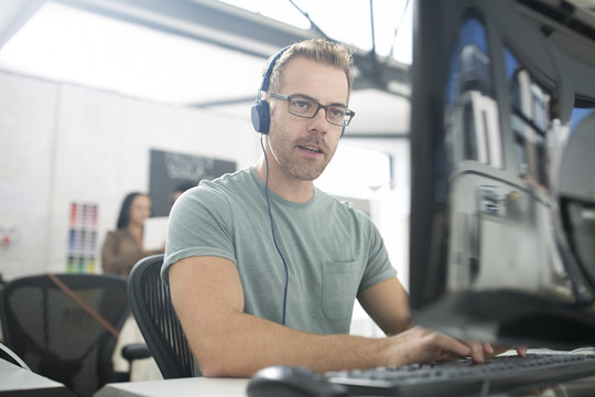 Employee wearing headphones at desk
