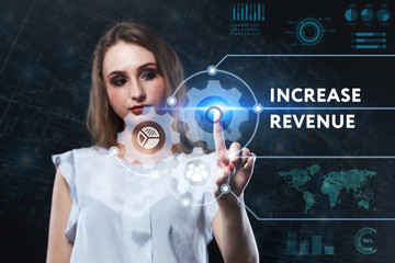 The concept of business, technology, the Internet and the network. A young entrepreneur working on a virtual screen of the future and sees the inscription: Increase revenue