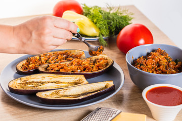 The cook fills the eggplant