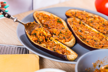 The cook fills the eggplant