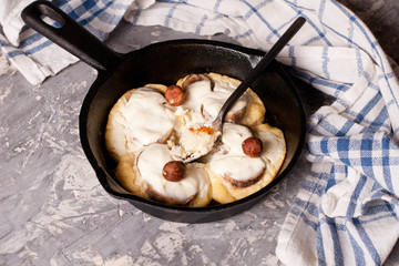 Cottage cheese pancakes with banana slices in frying pan, healthy breakfast, top view