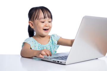 Asian Chinese little girl playing with laptop