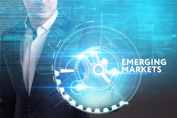 Business, Technology, Internet and network concept. Young businessman working on a virtual screen of the future and sees the inscription: Emerging markets