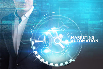 Fototapeta premium Business, Technology, Internet and network concept. Young businessman working on a virtual screen of the future and sees the inscription: Marketing automation