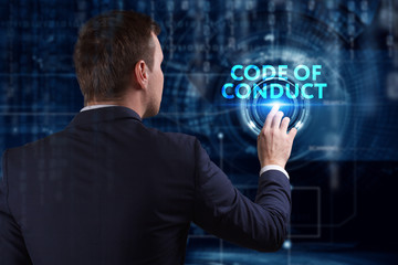 Business, Technology, Internet and network concept. Young businessman working on a virtual screen of the future and sees the inscription: Code of conduct