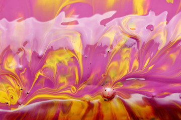 Smashing yellow and purple paint background, macro closeup.Texture