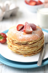 freshly prepared pancakes with strawberries