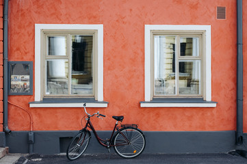 Fototapeta na wymiar the bike on the background of red walls with white Windows
