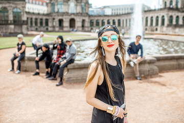 Fototapeta premium Young woman tourist walking with photo camera near the fountain in the old town of Dresden, Germany
