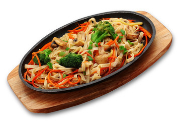 Udon noodels with vegetables and mashrooms on a stone plate isolated on white background