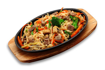Udon noodles with meat vegetables and mashrooms on a stone plate isolated on white background