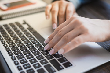 Obraz na płótnie Canvas Morning business woman. Female hands working on a laptop, close-up. Horizontal frame