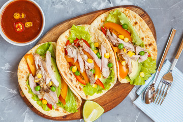 Fajitas with chicken, vegetables and spicy sauce salsa.