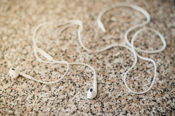 Fototapeta na wymiar White vacuum headphones on a granite background. Horizontal frame